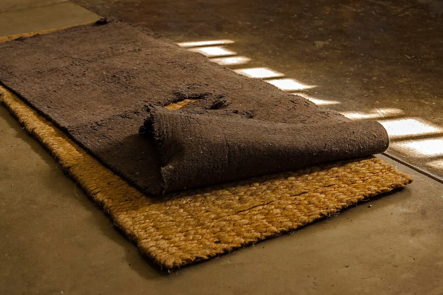 An inflatable sleeping pad unrolled on the ground